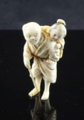 A Japanese ivory netsuke of a woman piggy-backing an injured man, Meiji period, 2in., repaired