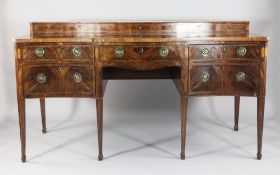 A George III banded mahogany serpentine sideboard, with unusual hinged top cellaret compartment,