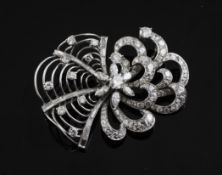 A stylish platinum and diamond set dress brooch, of scroll and spider`s web design, 2in.