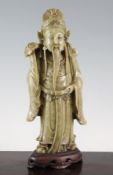A Chinese soapstone standing figure of an immortal, 19th century, holding a ruyi sceptre in his