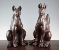 A pair of Japanese Bizen figures of Kitsune (foxes), modelled seated bearing a fierce expression,
