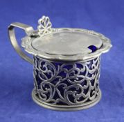 An early Victorian pierced silver drum mustard with scroll border and lid with engraved monogram,