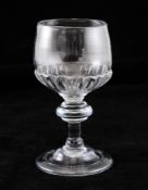 A George I mead glass, c.1710-20, the cup shaped bowl with gadrooning at the base, over a triple