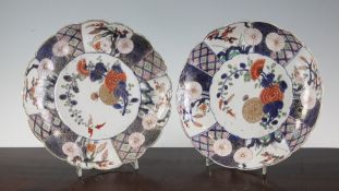 A pair of Japanese Arita scalloped dishes, 18th century, painted in Imari palette with flower sprays