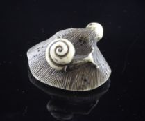 A Japanese walrus ivory netsuke of a snail on fungus, 19th century, 1.75in.