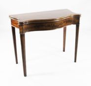 A George III mahogany serpentine folding card table, revealing a baize interior, on square section