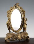 A late 19th century French oval ormolu dressing table mirror, decorated with figures, floral