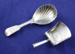 A George III silver shovel shaped caddy spoon, with engraved monogram within a thimble? John