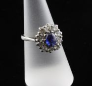 A 1970`s 18ct white gold, cabochon sapphire and diamond cluster ring, size O.