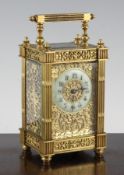 A late 19th century French gilt brass carriage timepiece, with blind fret work decorated case and