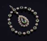 An Edwardian 9ct gold, peridot and seed pearl set pendant, of open circular form with central pear