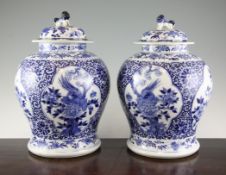 A pair of Chinese blue and white baluster jars and covers, Kangxi marks but late 19th century,