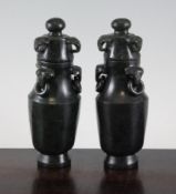 A pair of Chinese spinach green jade small vases and covers, 20th century each of baluster form with