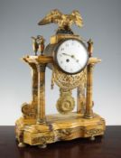 A second Empire ormolu mounted antico marble portico clock, surmounted with an eagle and urns,