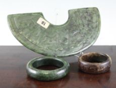 A Chinese spinach green jade, `Huang` and two jade bangles, all in archaistic style, 3.1 - 10.