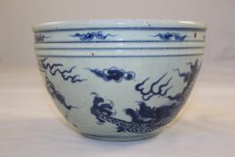 A Chinese blue and white `dragon bowl`, 8.5in. (21.5cm)