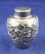 A Japanese Meiji silver tea caddy, of baluster form, embossed with dragons, with planished cover,