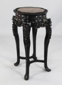 A 19th century Chinese carved rosewood jardiniere stand, with rouge marble inset top with pierced