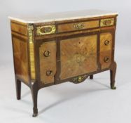 A Louis XVI style marquetry and gilt brass mounted marble top commode, fitted three long drawers,
