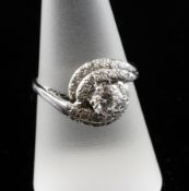 A platinum and diamond cluster ring, the central diamond weighing approximately 0.50ct with a