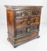 A late 17th century Italian walnut chest, of three long drawers over a dummy drawer, on shaped