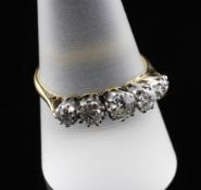 An 18ct gold and platinum graduated five stone diamond ring, size S.