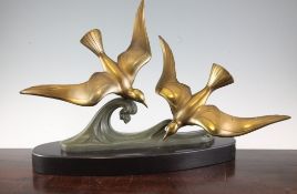 Deric. An Art Deco bronzed spelter group of two seagulls flying over waves, on signed black marble