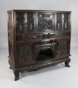 A 19th century Chinese hardwood cabinet, fitted with an arrangement of doors, fixed panels and