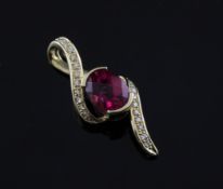 A 14ct gold, rubellite tourmaline and diamond set scroll pendant, 1in.