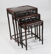A nest of three Chinese hardwood occasional tables, with prunus carved friezes, 1ft 8in. H.2ft 4in.