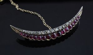 An Edwardian gold and silver, ruby and diamond set crescent brooch, 2.25in.