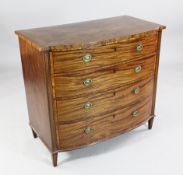 A Regency crossbanded and strung mahogany bowfront dressing chest, the top drawer with baize lined