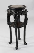 A late 19th century Chinese carved rosewood jardiniere stand, the octagonal inset with rouge marble,