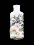 A Chinese moulded porcelain snuff bottle, 18th century, enamelled with the figure of a lion in a