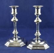 A pair of late Victorian 18th century design silver candlesticks, with turned panelled stems, on