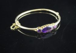 A gold and three stone amethyst stiff bracelet, set with navette and circular stones.