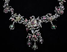 A mid 18th century French silver and gold multi gem set drop necklace, of scrolling foliate form,