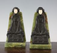 A pair of Art Deco bronze and ivory mounted green onyx bookends, by P. Tereszezuk, modelled as