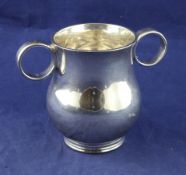 A late Victorian plain silver two handled loving cup, of baluster form, with ring handles, Josiah
