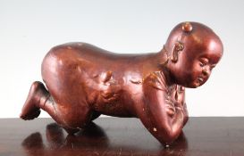 A Chinese lacquered pottery pillow, in the form of a kneeling boy, 15in. (38.5cm)Provenance: