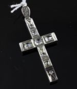 An early 20th century silver and old rose cut diamond cross pendant, set with eleven stones, 2in