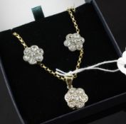 A suite of gold and diamond set jewellery, of flowerhead design, comprising pair of earrings and