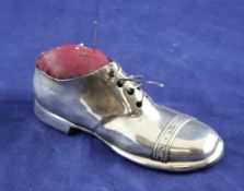 A George V novelty silver pin cushion, modelled as a gentleman`s shoe, with wooden base, S.