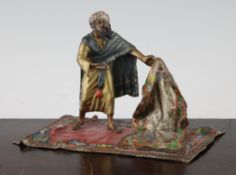 A 19th century Bergman Austrian cold painted bronze model of an Arab carpet seller, standing on a