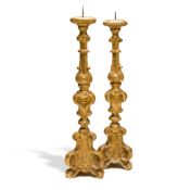 A PAIR OF CARVED LIMEWOOD AND GILDED PRICKET ALTAR STICKS, CONTINENTAL, CIRCA 1700, with turned