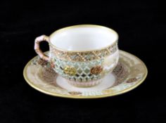 A Royal Worcester `jewelled` and reticulated coffee cup and saucer, c.1881 and 1884, with gilt