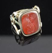 An early 19th century gold and carnelian set intaglio ring, with rounded rectangular stone carved