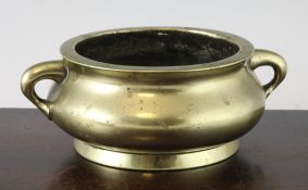 A Chinese bronze two handled censer, of compressed baluster form with a pair of looped lug