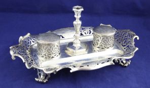 A Victorian silver desk stand by The Barnards, of shaped rectangular form, with pierced and scroll