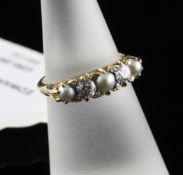 An Edwardian gold, split pearl and diamond half hoop ring, with pierced scroll setting, size L.